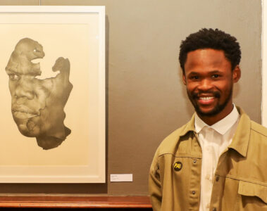 The Portrait Awards Winner 2025 Malik Mani with his work, "Mask", pencil on paper.
